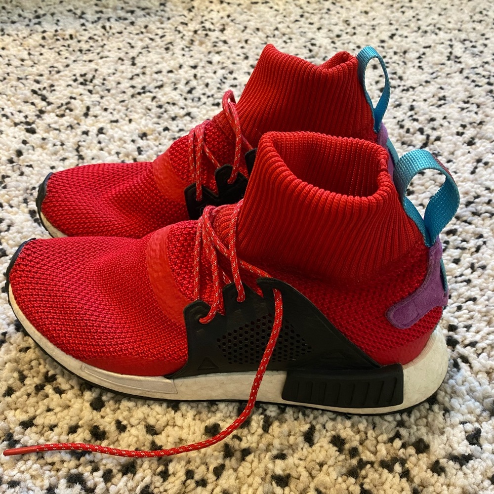 Men’s Adidas NMD red sneakers.